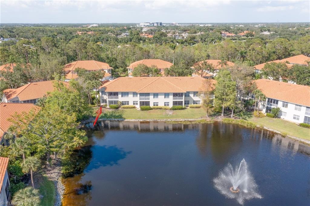 1072 Egrets Walk Circle, Unit 104 Naples, FL 34108 - Photo 4 of 37 a view of a lake with a mountain