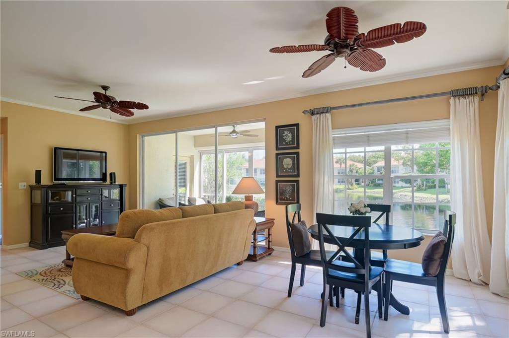 1072 Egrets Walk Circle, Unit 104 Naples, FL 34108 - Photo 6 of 37 a living room with furniture and a flat screen tv