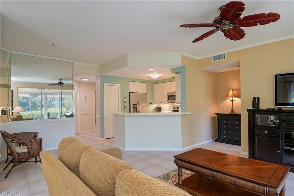1072 Egrets Walk Circle, Unit 104 Naples, FL 34108 - Photo 9 of 37 a living room with furniture and a flat screen tv