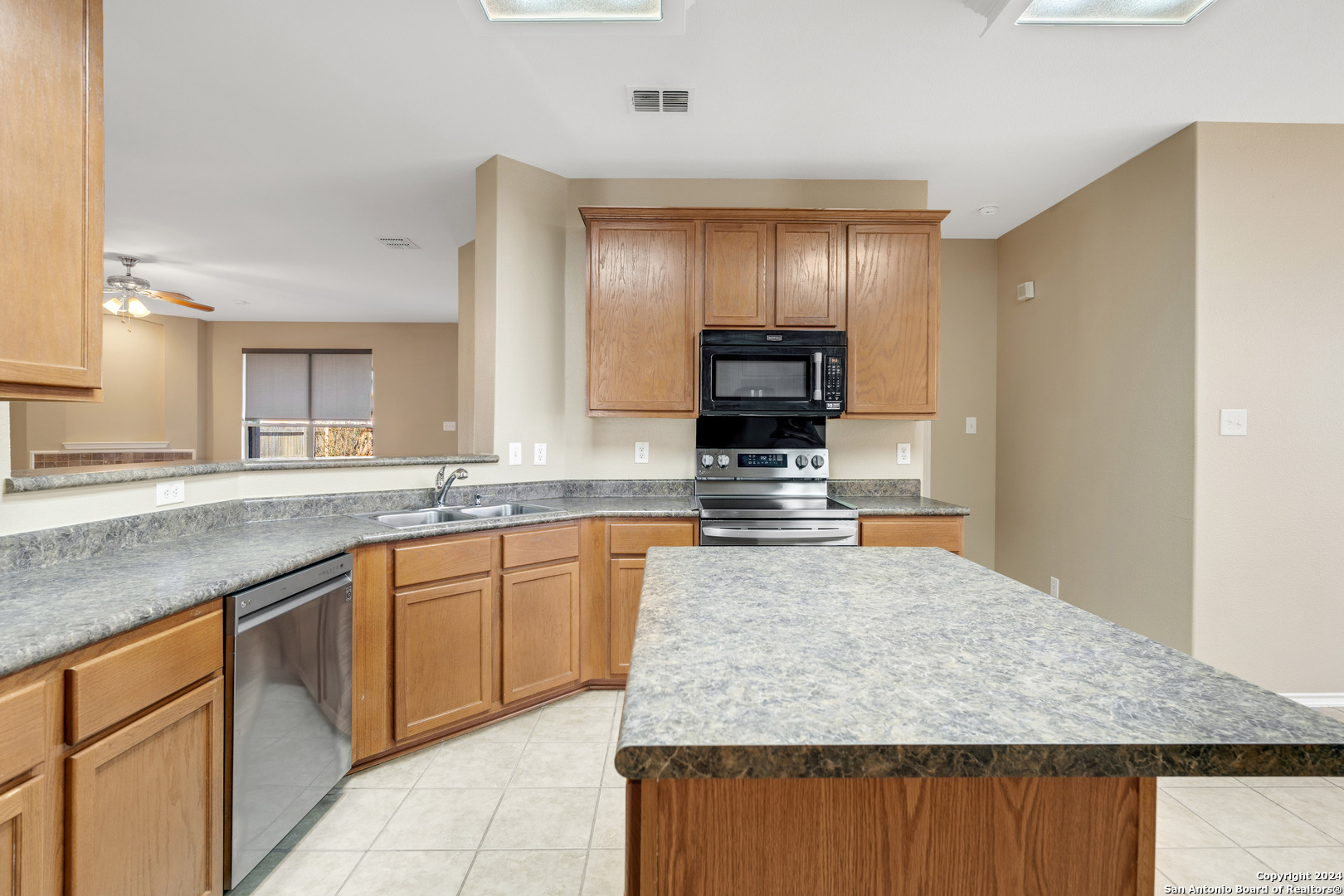 225 Crimson Tree Cibolo, TX 78108 - Photo 13 of 34 a large kitchen with kitchen island granite countertop a large counter top and sink
