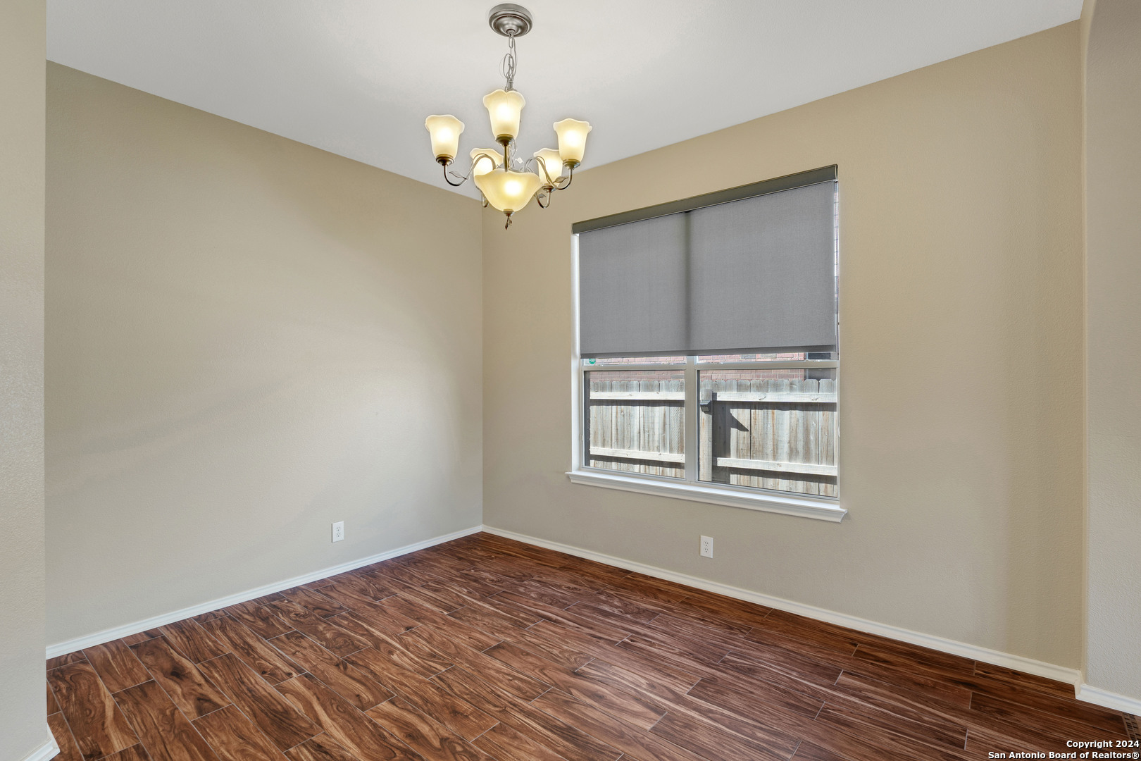225 Crimson Tree Cibolo, TX 78108 - Photo 17 of 34 a view of an empty room with wooden floor and a window