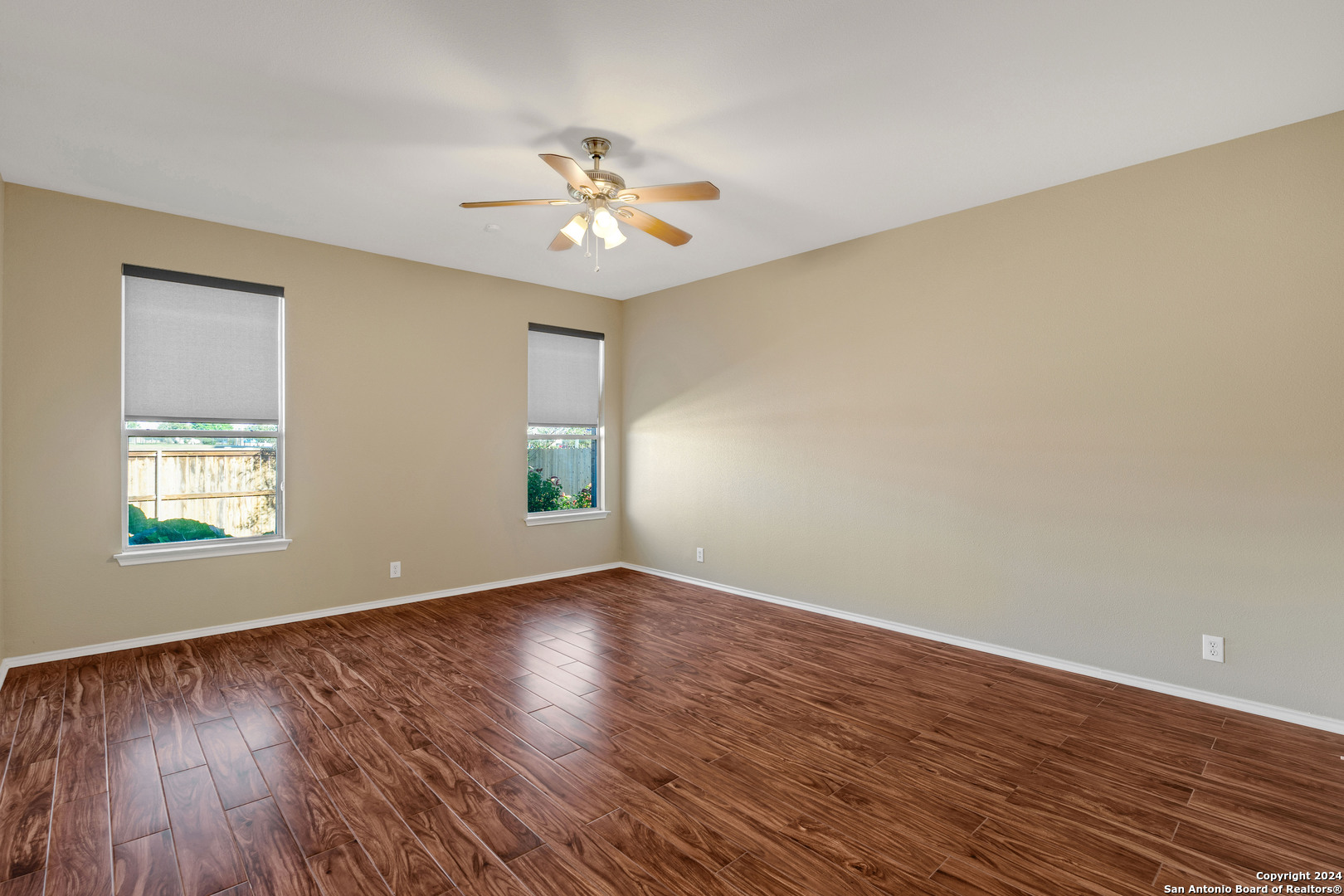 225 Crimson Tree Cibolo, TX 78108 - Photo 19 of 34 a view of an empty room with wooden floor and a window
