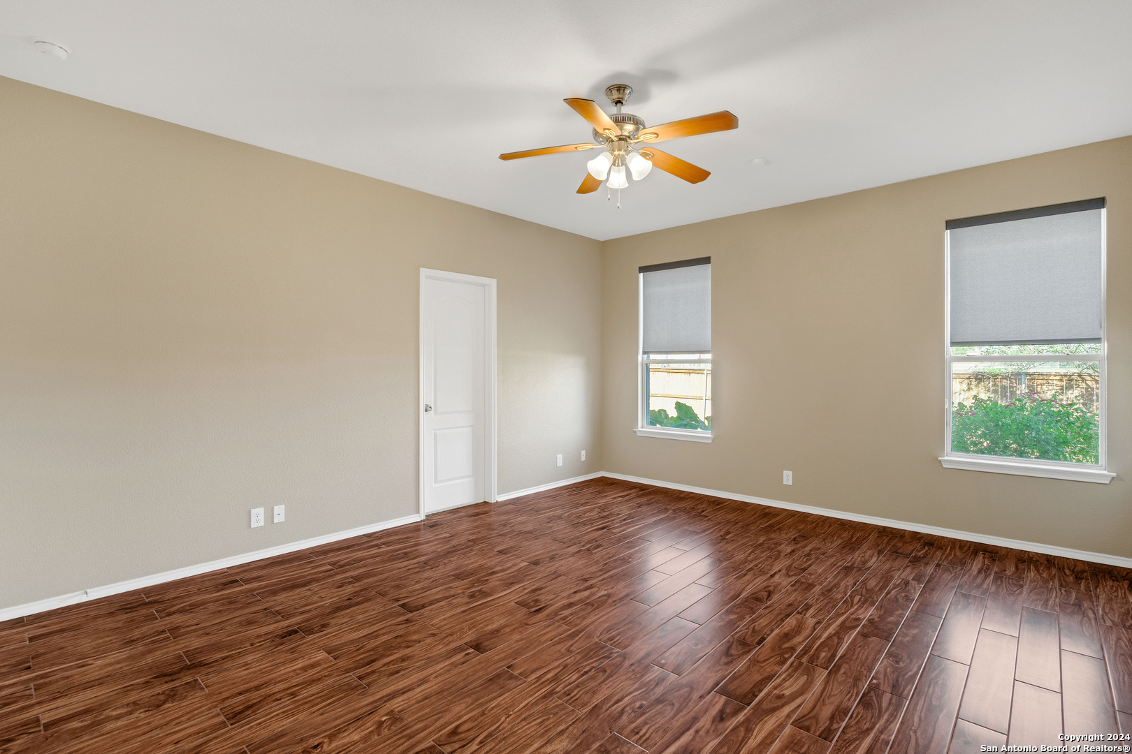 225 Crimson Tree Cibolo, TX 78108 - Photo 20 of 34 a view of an empty room with wooden floor and a window