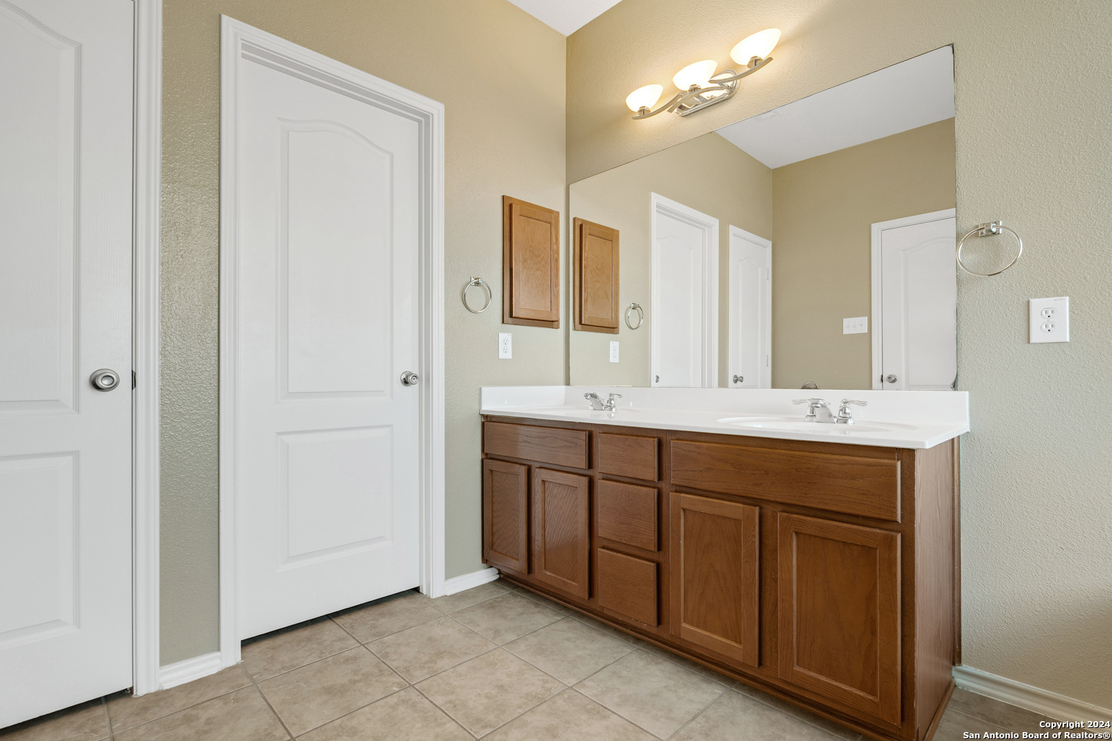 225 Crimson Tree Cibolo, TX 78108 - Photo 26 of 34 a bathroom with a double vanity sink and a mirror