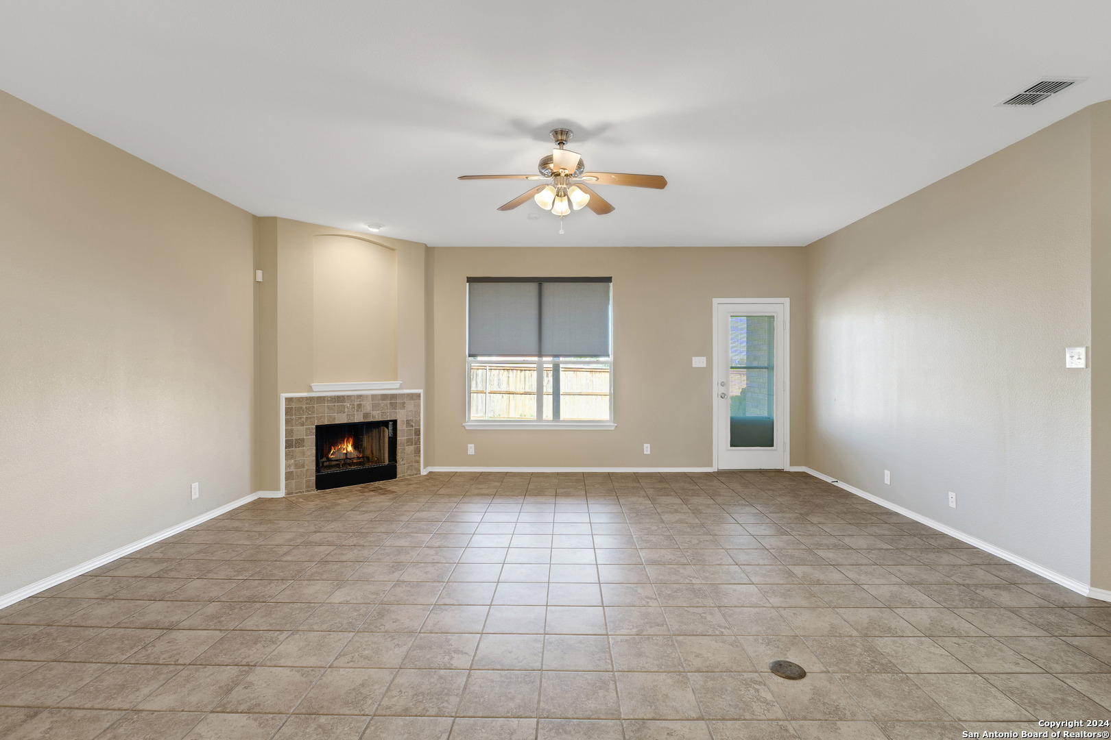 225 Crimson Tree Cibolo, TX 78108 - Photo 5 of 34 a view of an empty room with a fireplace and a window