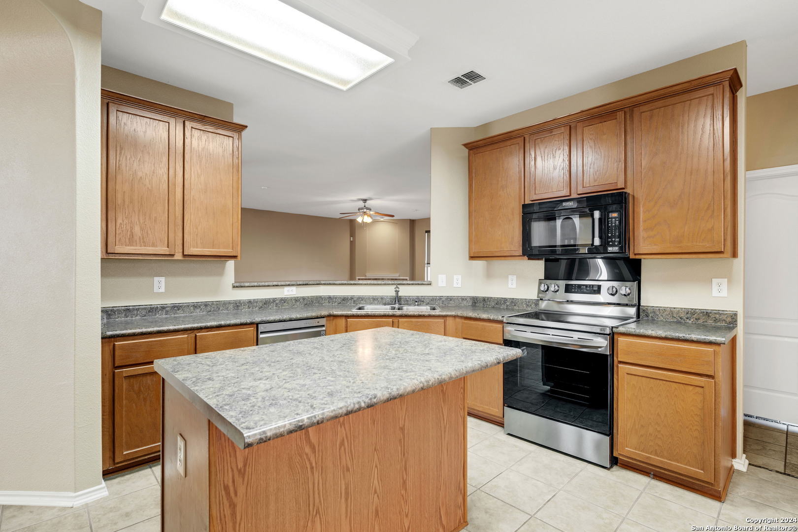 225 Crimson Tree Cibolo, TX 78108 - Photo 9 of 34 a kitchen with stainless steel appliances granite countertop a sink stove and refrigerator