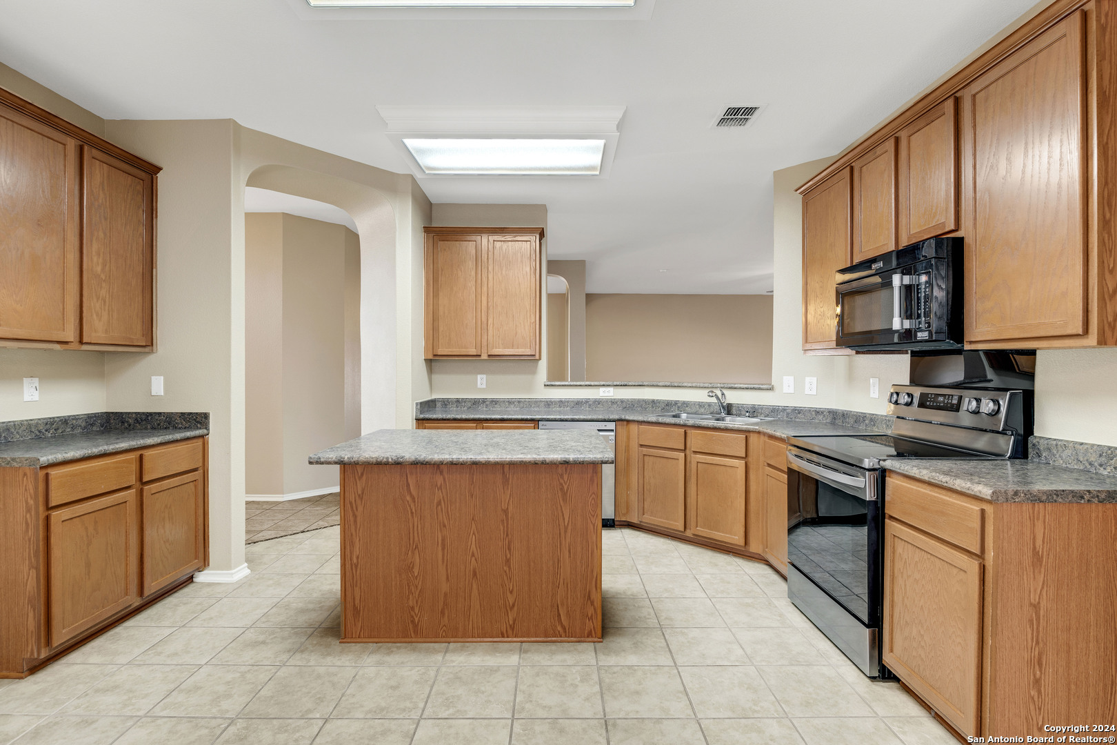 225 Crimson Tree Cibolo, TX 78108 - Photo 10 of 34 a kitchen with stainless steel appliances granite countertop a stove top oven a sink dishwasher and granite countertops with cabinets