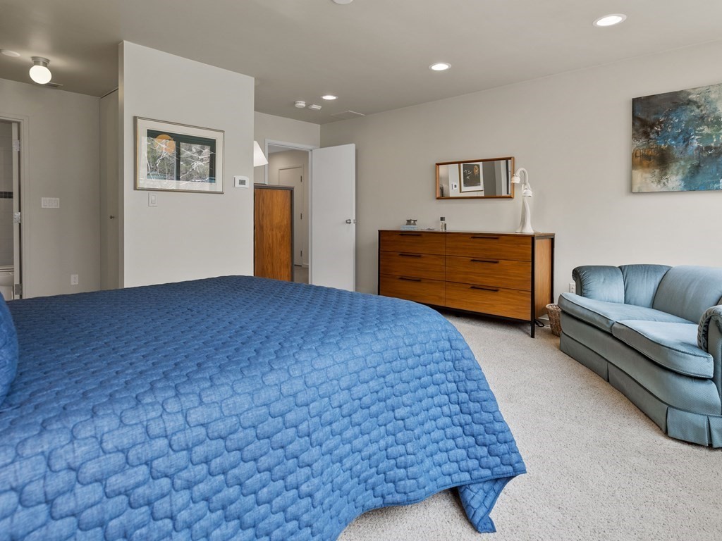 241 Perkins Street, Unit A602 Boston, MA 02130 - Photo 14 of 24 a bed room with a bed and furniture
