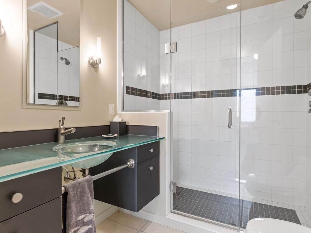 241 Perkins Street, Unit A602 Boston, MA 02130 - Photo 16 of 24 a bathroom with a sink and a mirror