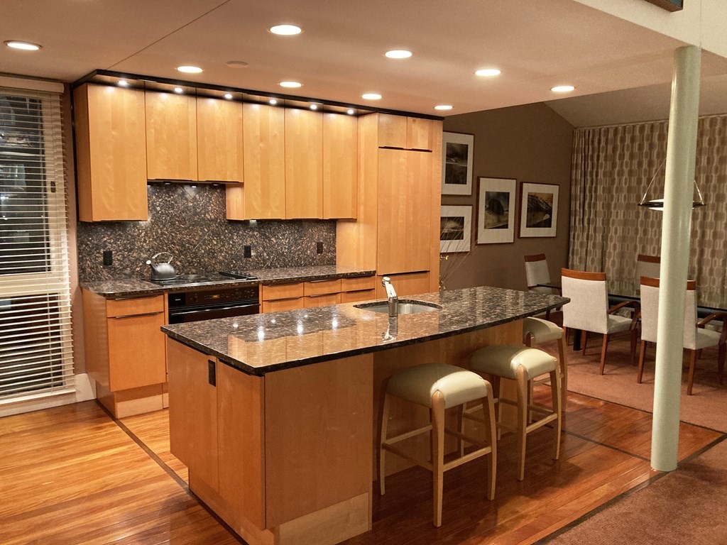 241 Perkins Street, Unit A602 Boston, MA 02130 - Photo 23 of 24 a kitchen with stainless steel appliances granite countertop a sink a stove and a refrigerator