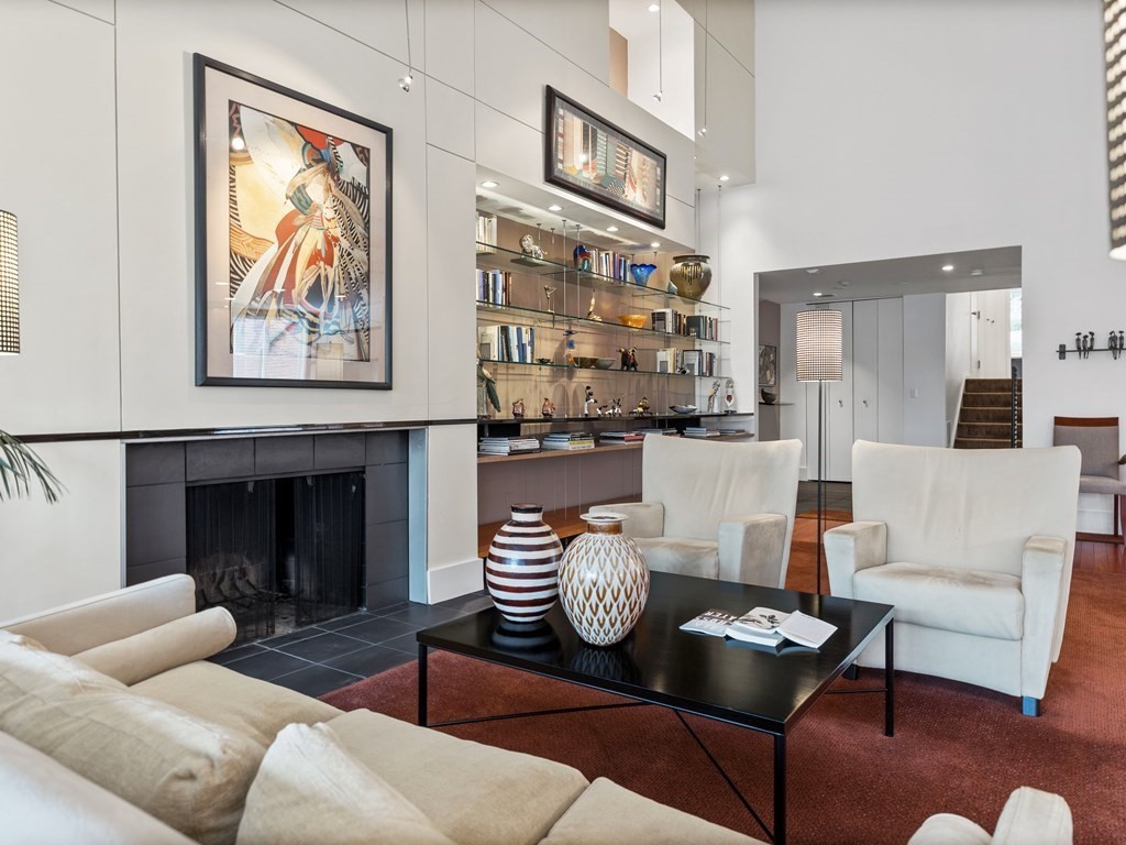 241 Perkins Street, Unit A602 Boston, MA 02130 - Photo 6 of 24 a living room with furniture kitchen view and a fireplace