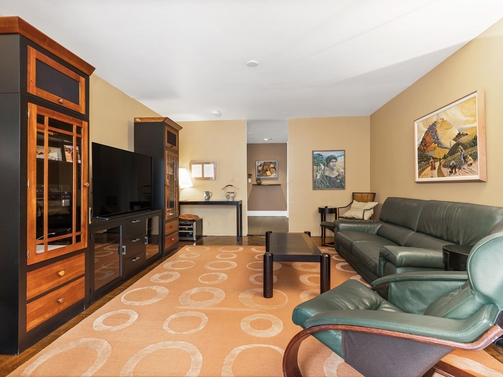 241 Perkins Street, Unit A602 Boston, MA 02130 - Photo 8 of 24 a living room with furniture and a flat screen tv