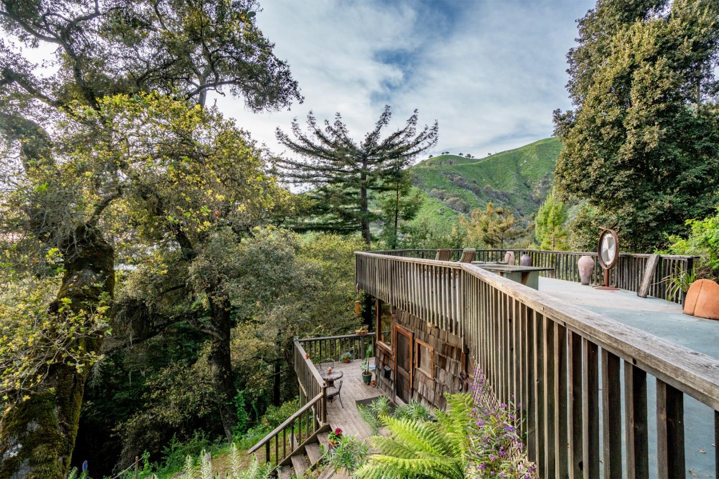 37763 Palo Colorado Road Carmel, CA 93923 - Photo 21 of 32 a balcony with wooden floor and trees in the back
