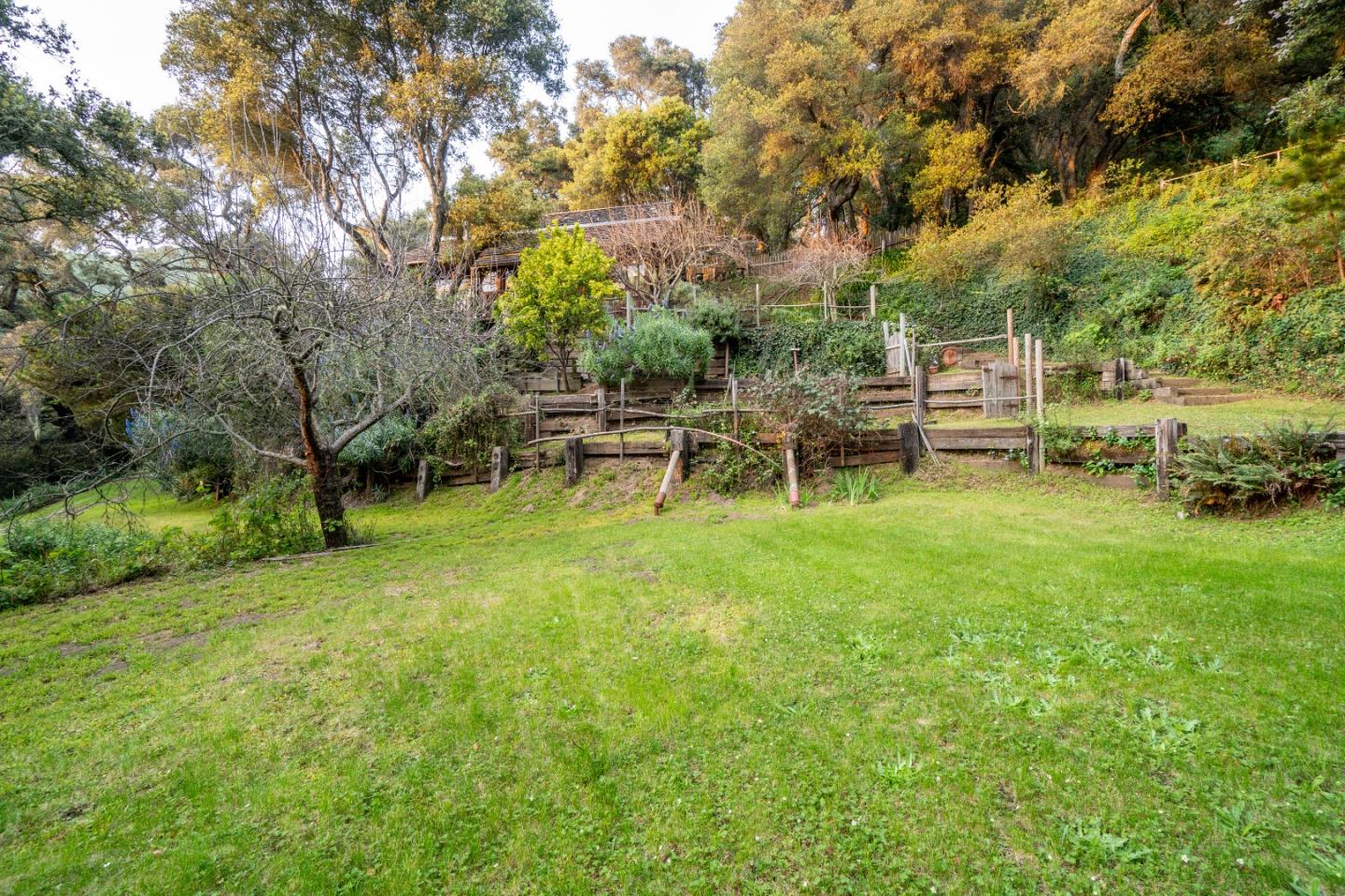37763 Palo Colorado Road Carmel, CA 93923 - Photo 25 of 32 a view of a bench in the garden near a lake