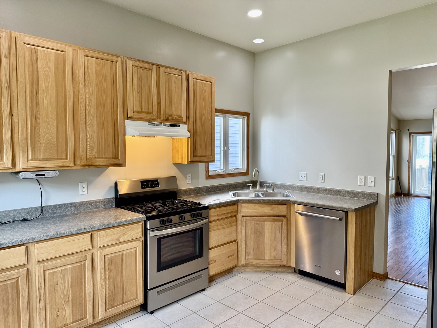 317 Plymouth Court Sycamore, IL 60178 - Photo 2 of 18 a kitchen with granite countertop a sink stainless steel appliances and cabinets