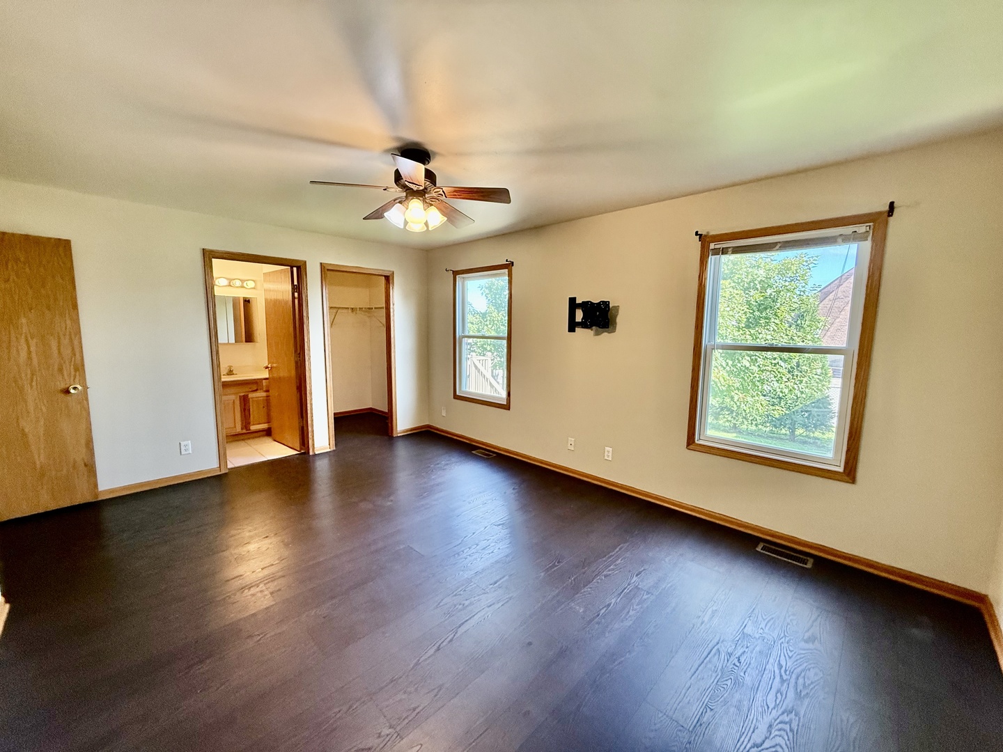 317 Plymouth Court Sycamore, IL 60178 - Photo 7 of 18 a view of an empty room with wooden floor and a window
