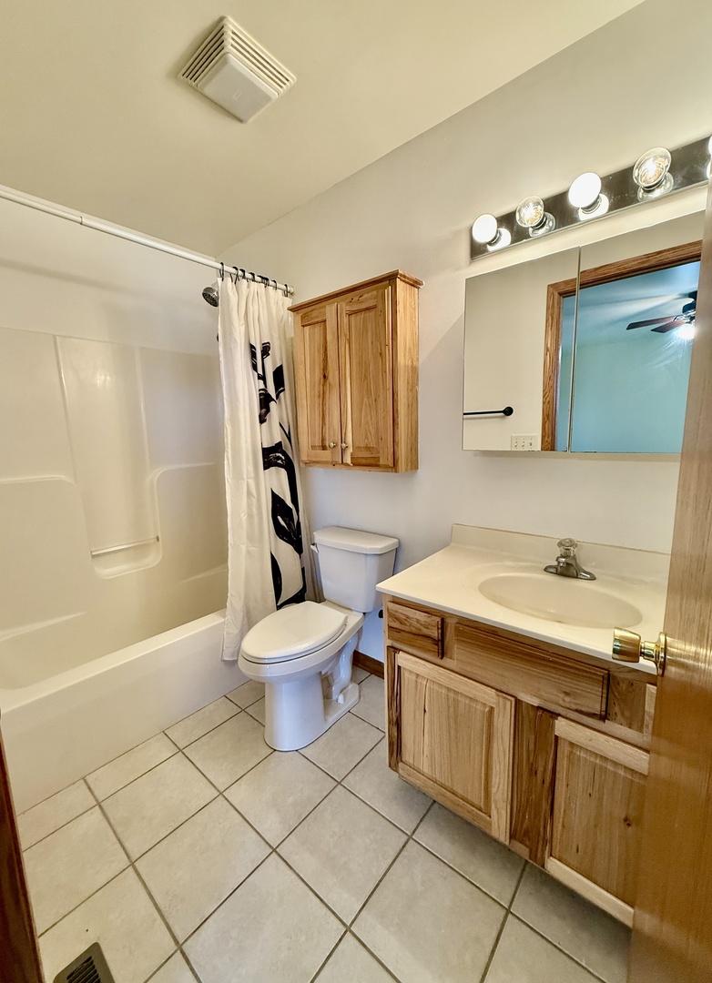 317 Plymouth Court Sycamore, IL 60178 - Photo 8 of 18 a bathroom with a sink a toilet and shower