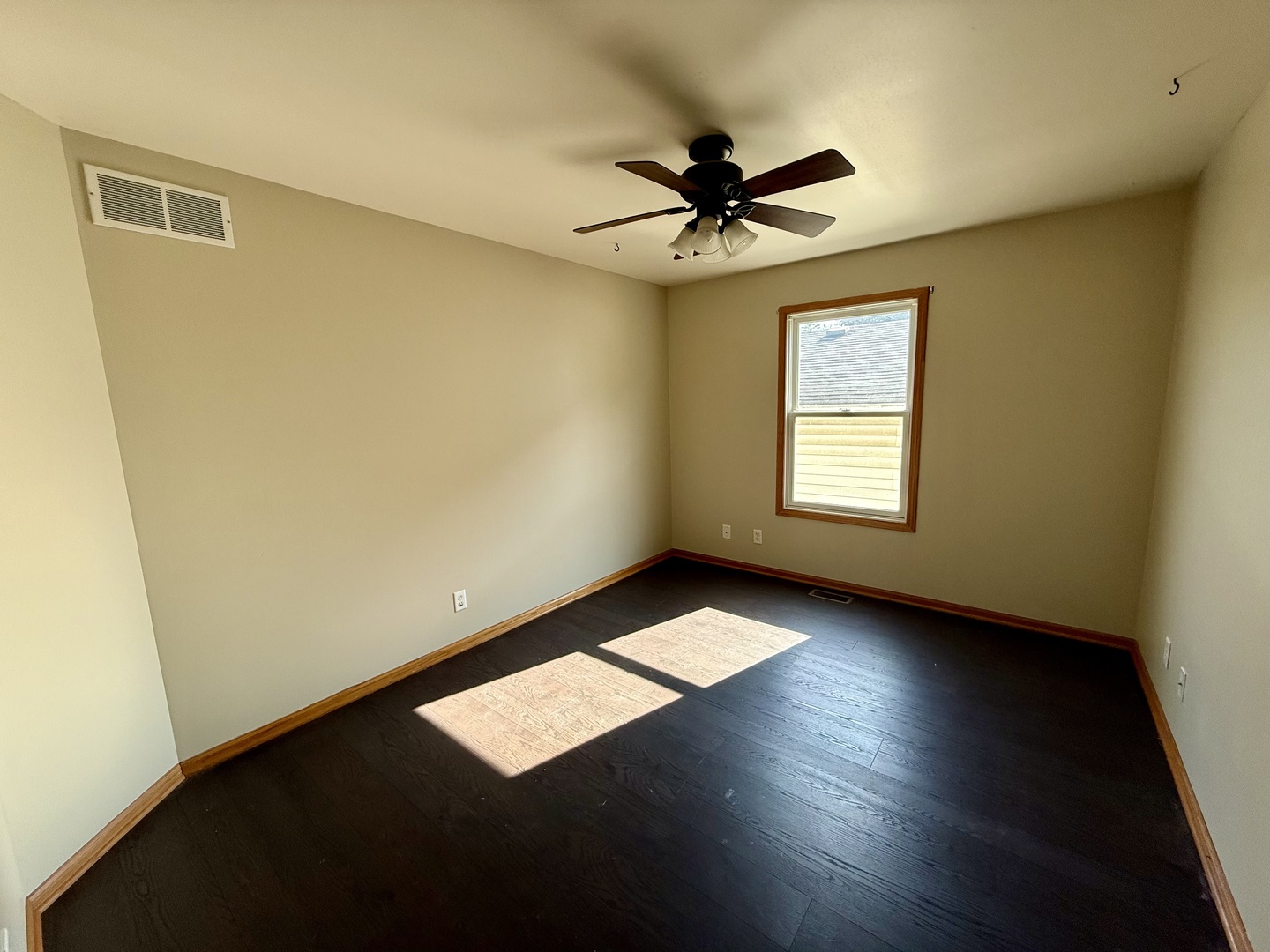 317 Plymouth Court Sycamore, IL 60178 - Photo 9 of 18 a view of an empty room with a window and wooden floor