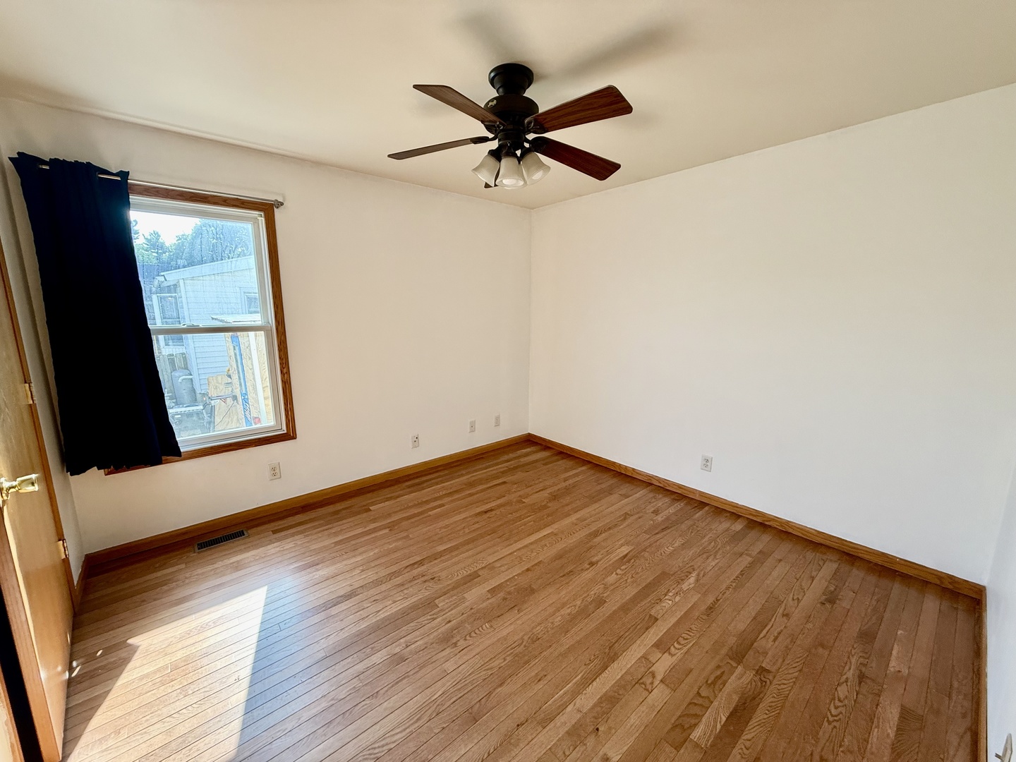 317 Plymouth Court Sycamore, IL 60178 - Photo 10 of 18 a view of empty room with wooden floor and fan