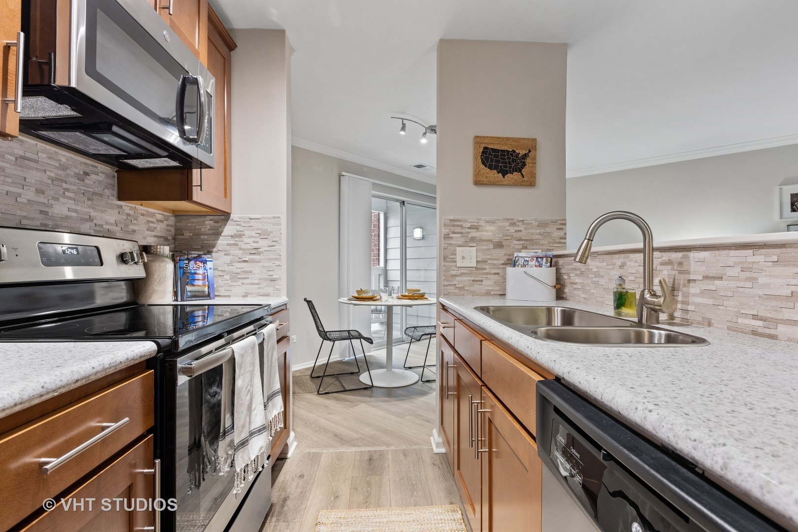 1711 Buttonwood Circle, Unit 2821 Schaumburg, IL 60173 - Photo 6 of 27 a kitchen with stainless steel appliances granite countertop a sink stove and cabinets