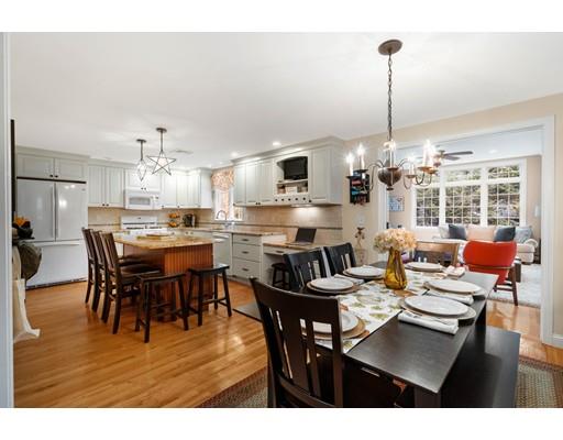 10 Hemlock Road Reading, MA 01867 - Photo 13 of 42 a view of a dining room and livingroom furniture a rug a chandelier and wooden floor