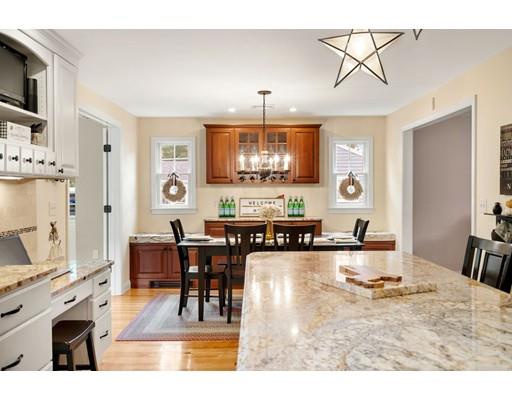 10 Hemlock Road Reading, MA 01867 - Photo 14 of 42 a living room with stainless steel appliances kitchen island granite countertop furniture and a fireplace