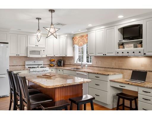 10 Hemlock Road Reading, MA 01867 - Photo 17 of 42 a kitchen with a dining table chairs and white appliances