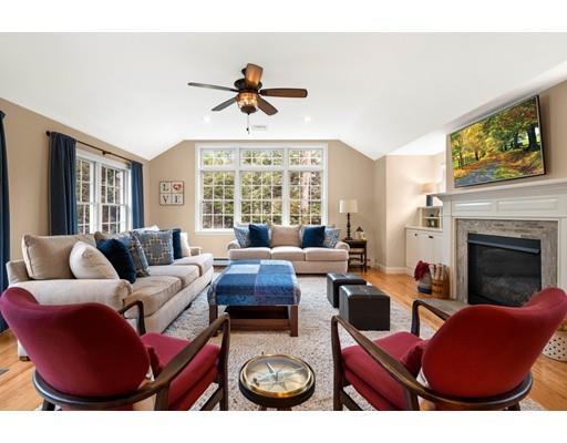 10 Hemlock Road Reading, MA 01867 - Photo 20 of 42 a living room with furniture a fireplace and a large window