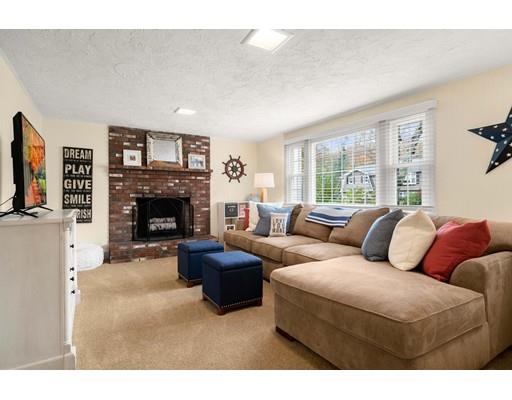10 Hemlock Road Reading, MA 01867 - Photo 28 of 42 a living room with furniture a flat screen tv and a fireplace