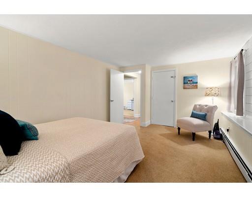 10 Hemlock Road Reading, MA 01867 - Photo 30 of 42 a bedroom with a bed and a couch