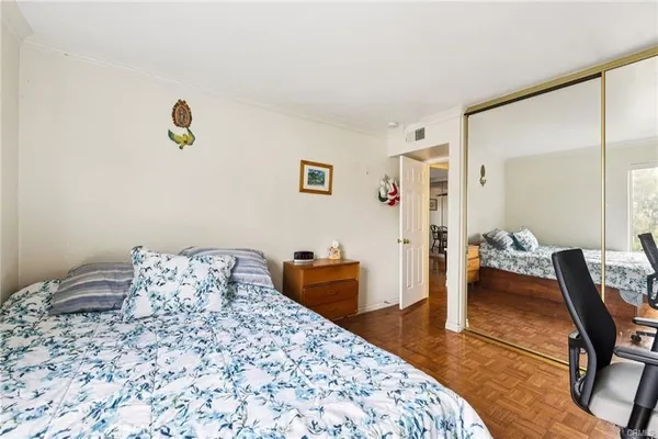 a bedroom with a bed and a chair