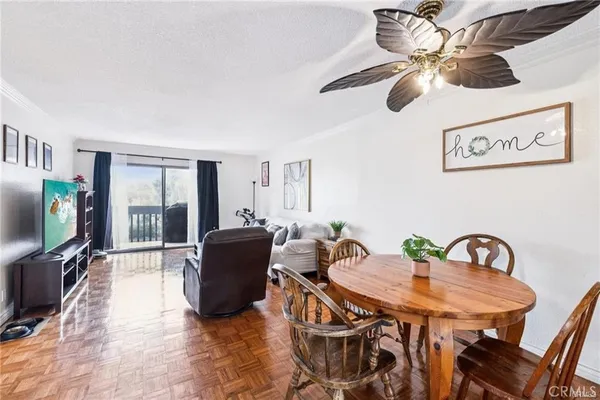 a living room with furniture a flat screen tv and a window