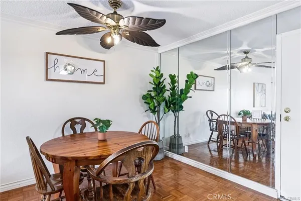 a view of a dining room with furniture and chandelier
