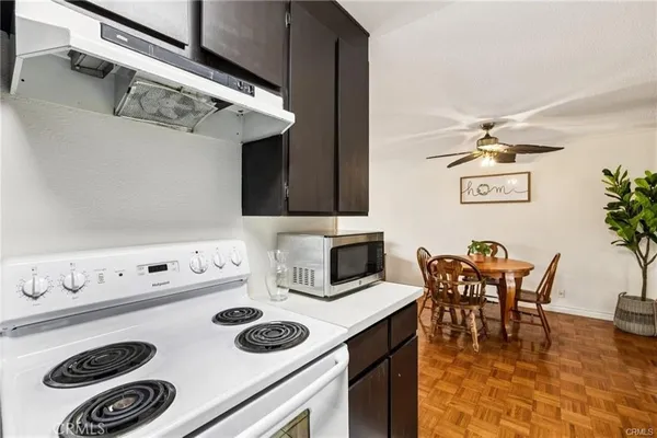 a kitchen with a cabinets a dining table and chairs