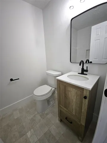a bathroom with a sink toilet and mirror