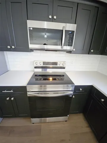 a stove top oven sitting inside of a kitchen