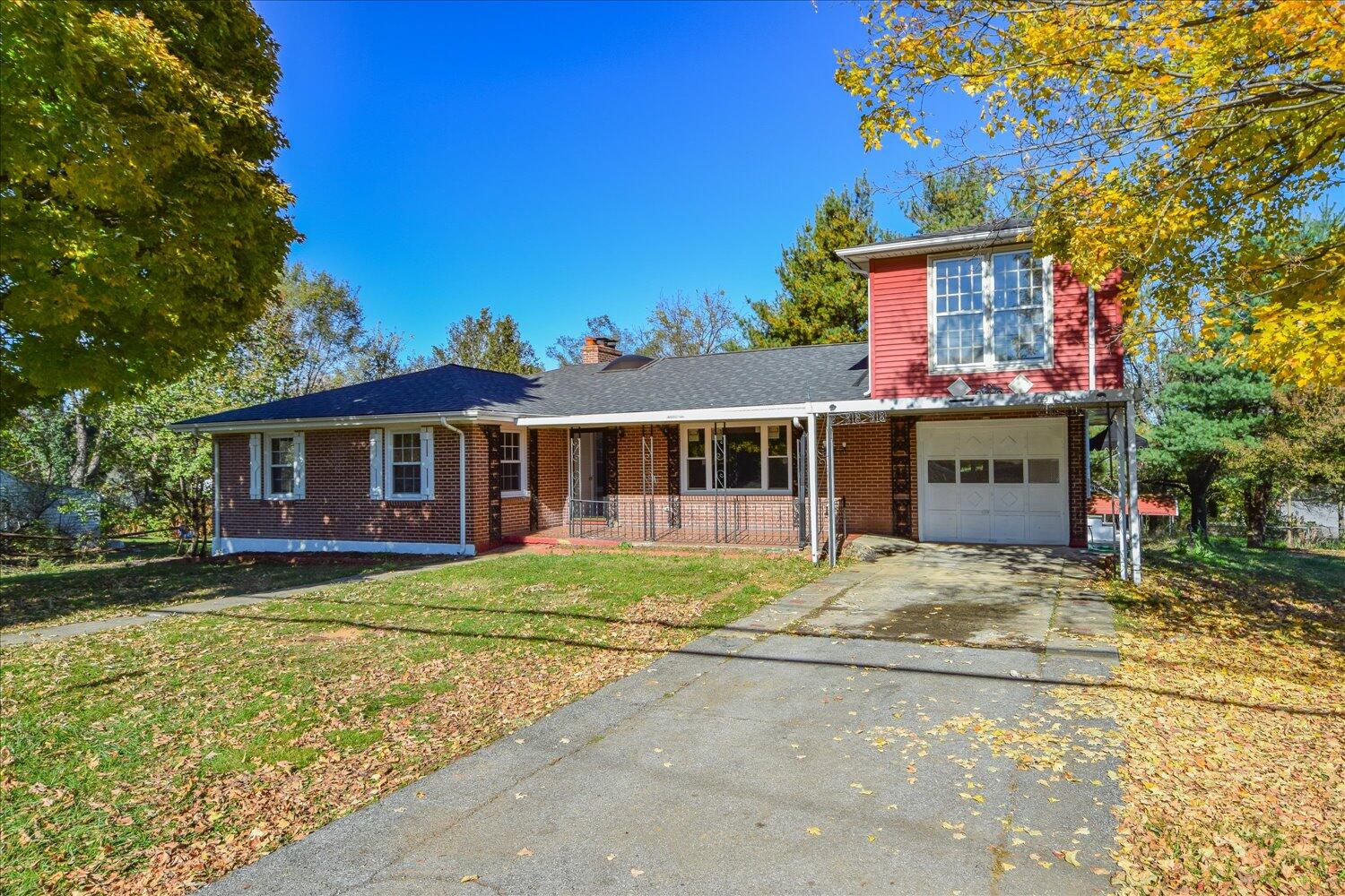 3703 Cove Road Roanoke, VA 24017 - Photo 1 of 27 a front view of a house with a garden