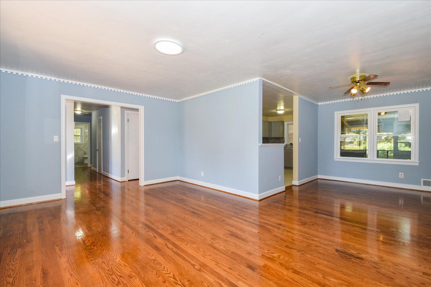 3703 Cove Road Roanoke, VA 24017 - Photo 2 of 27 an empty room with wooden floor and windows