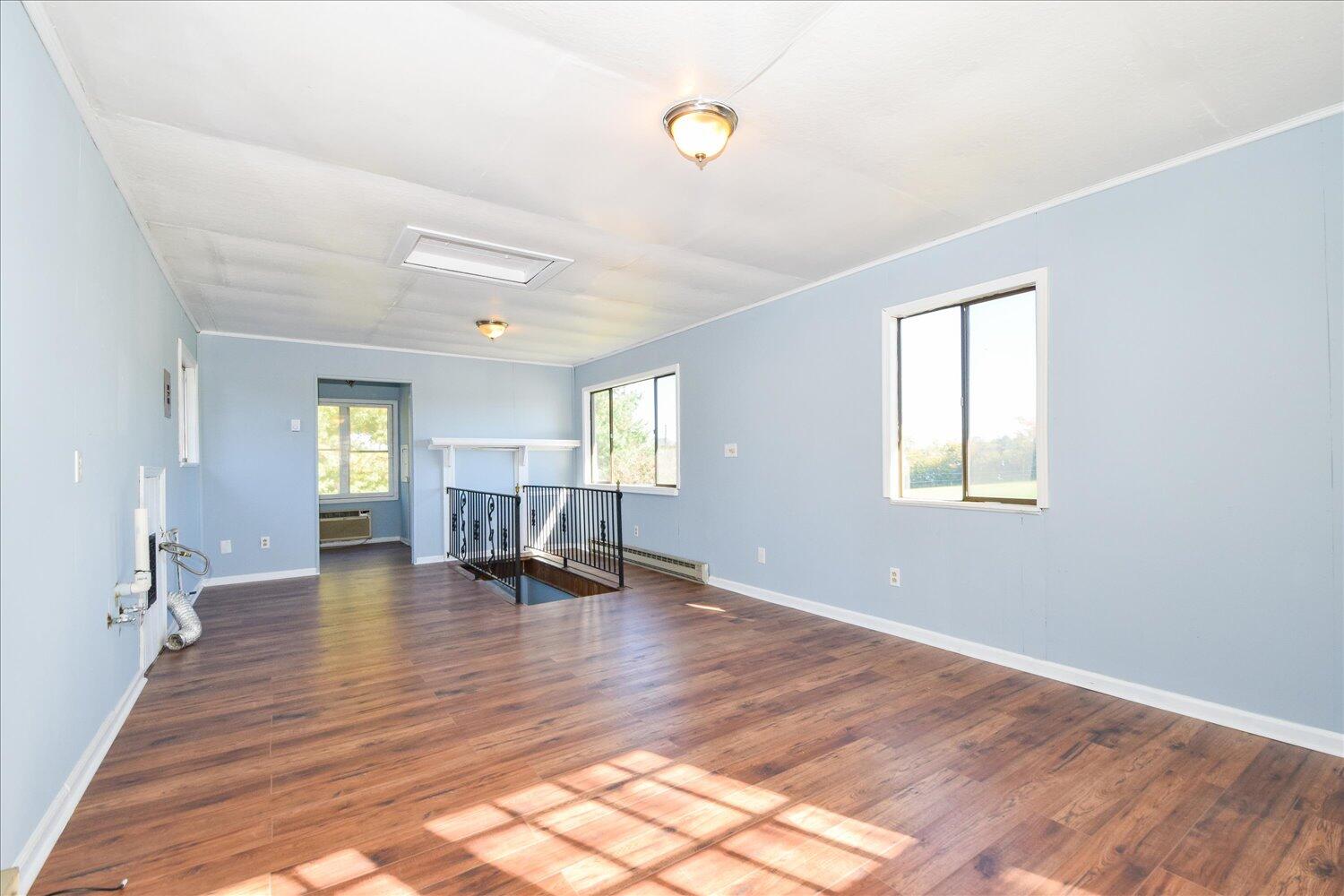 3703 Cove Road Roanoke, VA 24017 - Photo 14 of 27 a view of empty room with wooden floor and fireplace