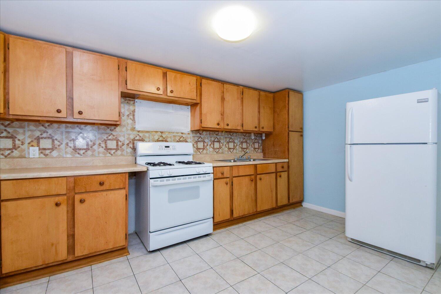 3703 Cove Road Roanoke, VA 24017 - Photo 16 of 27 a kitchen with a stove a sink and a refrigerator