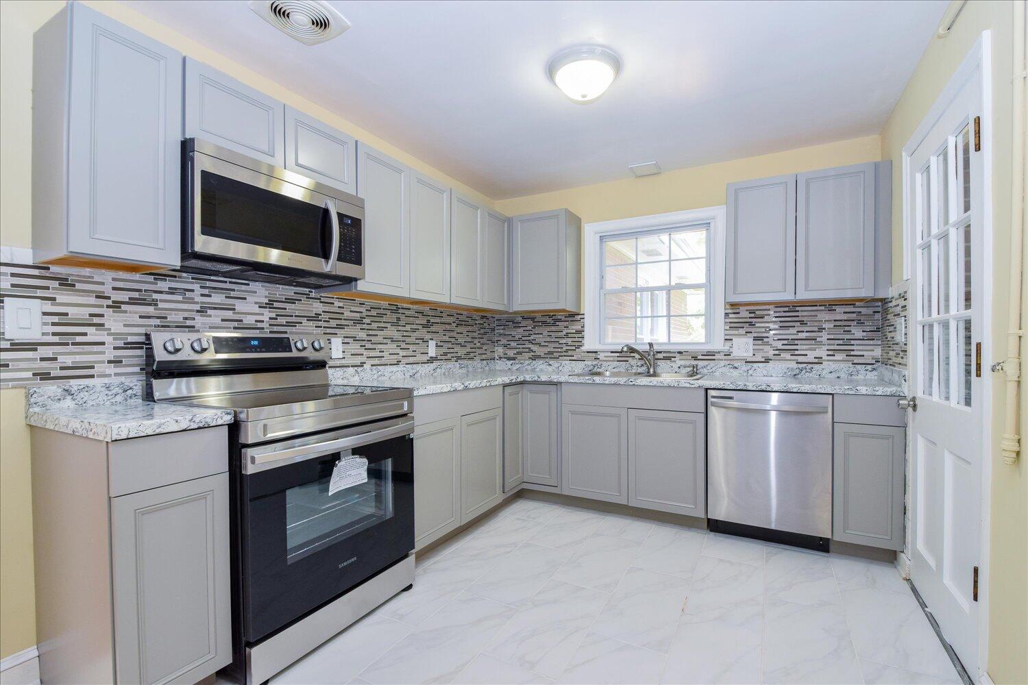3703 Cove Road Roanoke, VA 24017 - Photo 3 of 27 a kitchen with stainless steel appliances granite countertop a stove microwave and sink