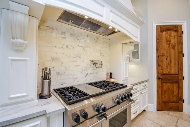 a kitchen with a stove and a refrigerator
