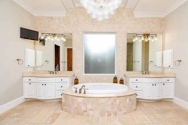 a bathroom with a tub sink and mirror