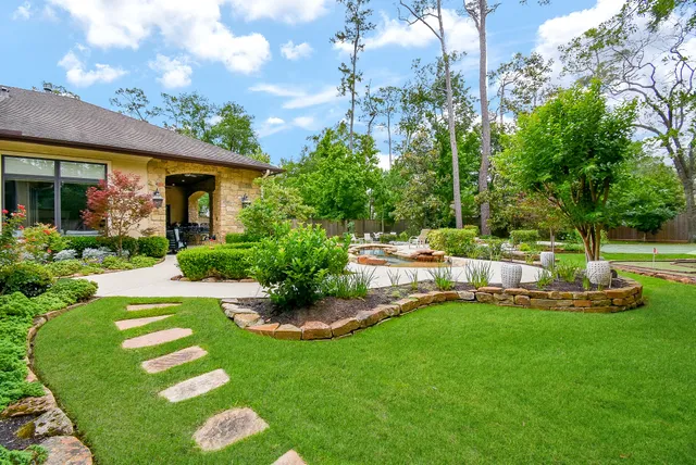 a view of a house with a yard patio and swimming pool