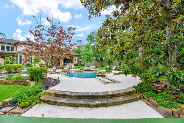 a view of a house with swimming pool and sitting area