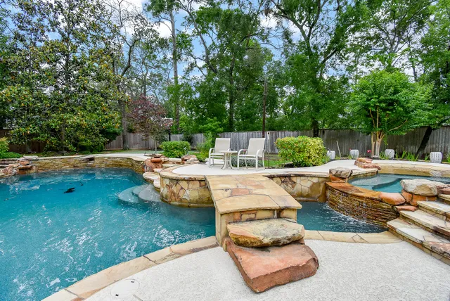 a view of a backyard with swimming pool