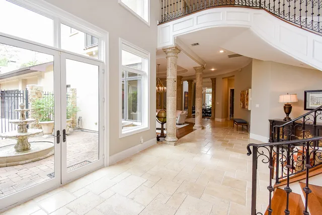 a lobby with furniture and floor to ceiling window