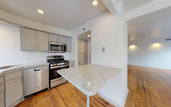 a kitchen with stainless steel appliances granite countertop a sink stove and microwave