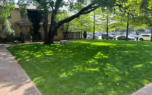 a view of a house with a backyard