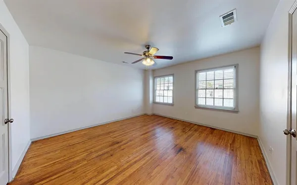 wooden floor in an empty room with a window